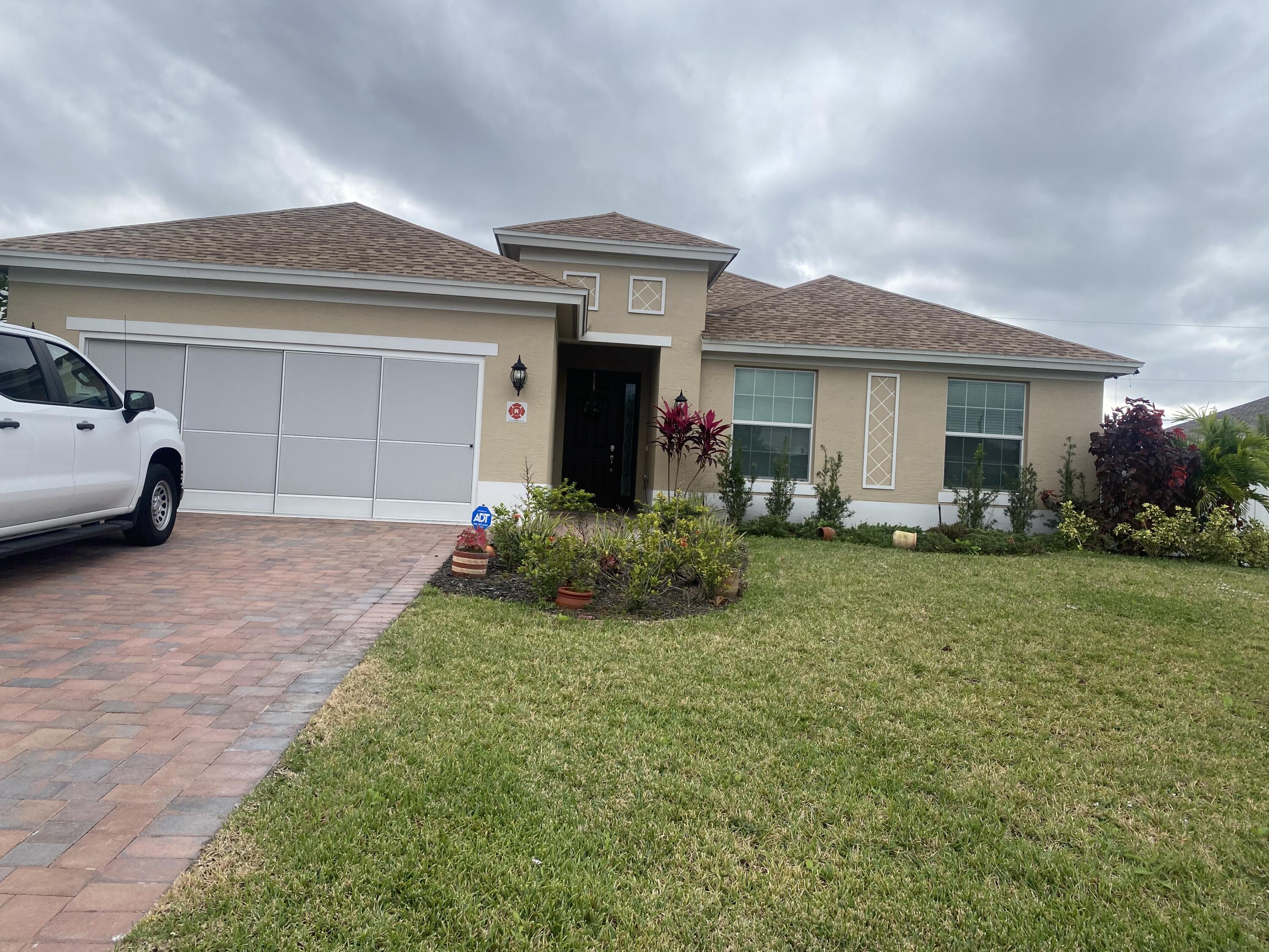 656 Southwest Haas Avenue Port St. Lucie, FL 34953 - Photo 1 of 31 a view of house with yard and entertaining space