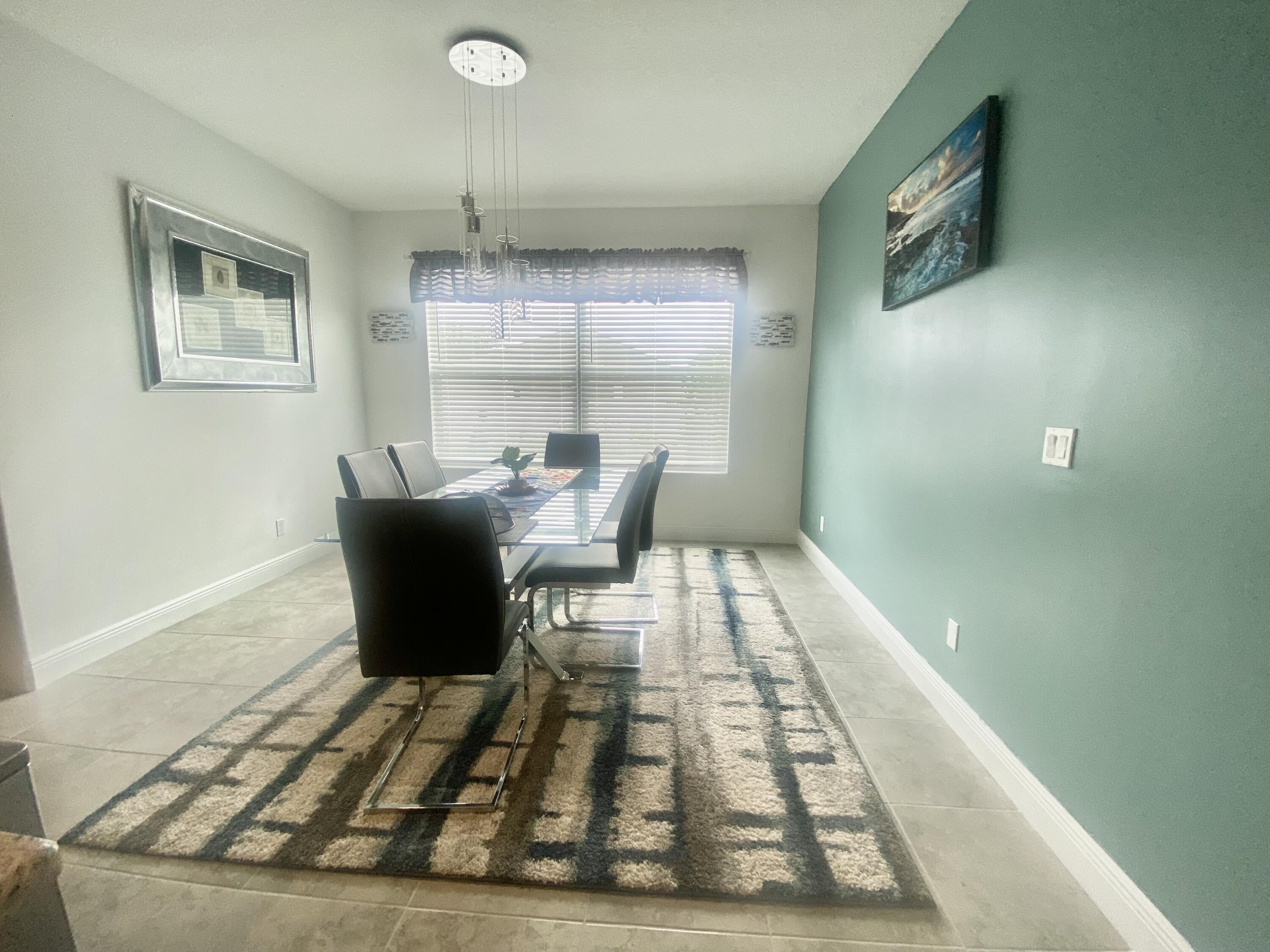 656 Southwest Haas Avenue Port St. Lucie, FL 34953 - Photo 16 of 31 a living room with a couch and a rug