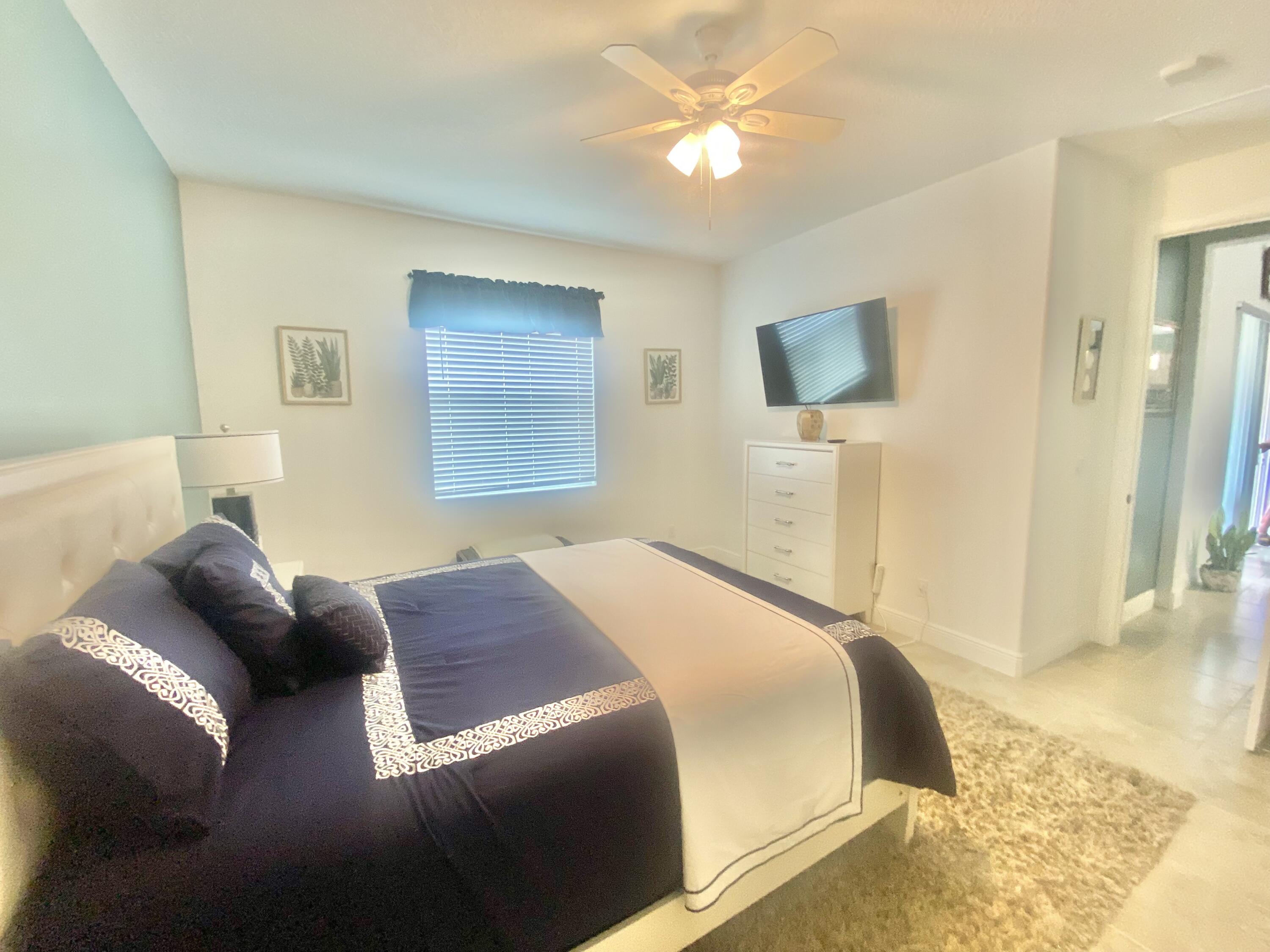 656 Southwest Haas Avenue Port St. Lucie, FL 34953 - Photo 18 of 31 a bedroom with a bed and a couch