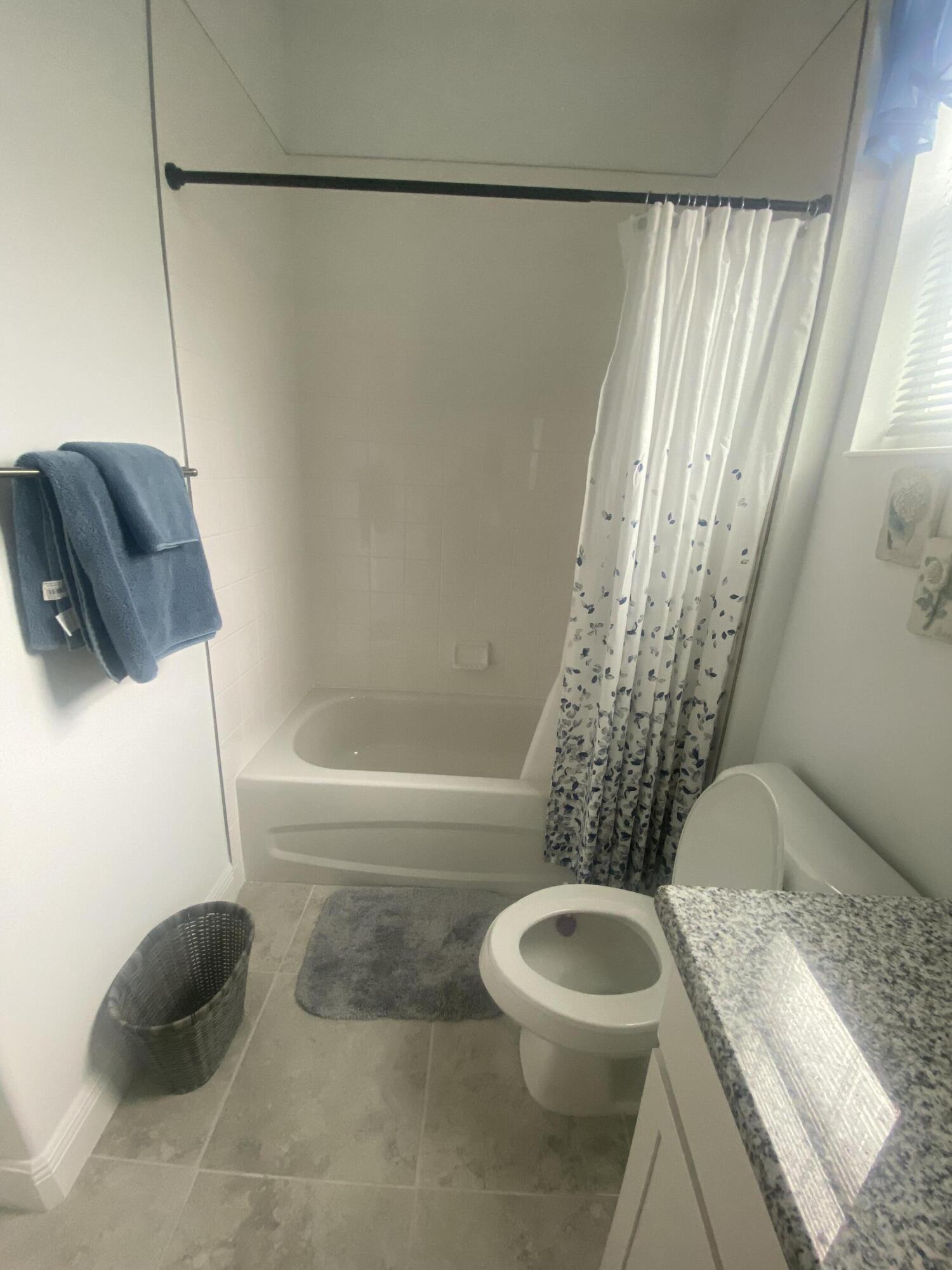 656 Southwest Haas Avenue Port St. Lucie, FL 34953 - Photo 20 of 31 a bathroom with a toilet and a shower