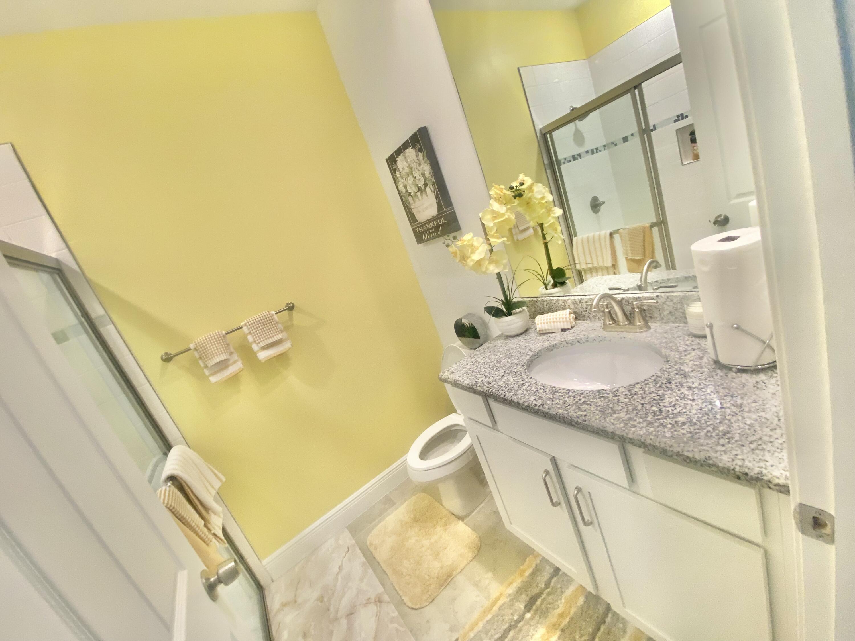 656 Southwest Haas Avenue Port St. Lucie, FL 34953 - Photo 26 of 31 a bathroom with a granite countertop sink and a mirror