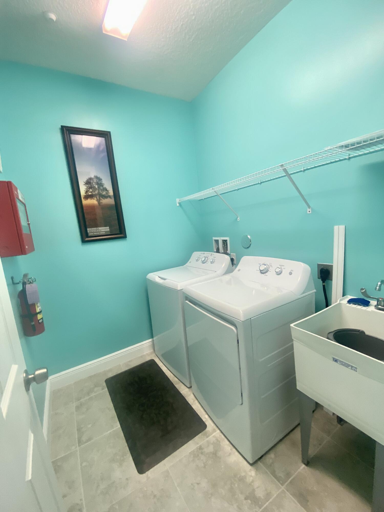 656 Southwest Haas Avenue Port St. Lucie, FL 34953 - Photo 31 of 31 a utility room with a washer and dryer