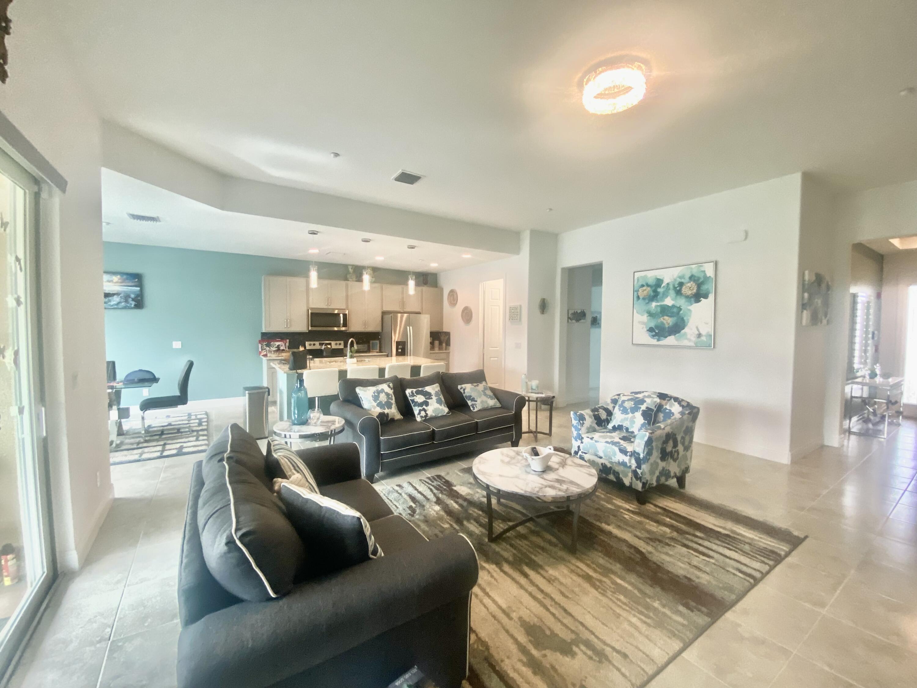 656 Southwest Haas Avenue Port St. Lucie, FL 34953 - Photo 6 of 31 a living room with furniture and a table