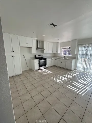 a kitchen with a stove and cabinets