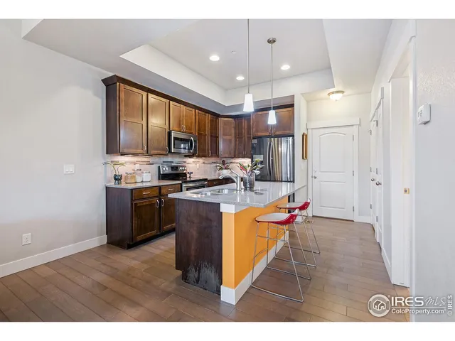 a kitchen with kitchen island granite countertop a stove a sink and a refrigerator