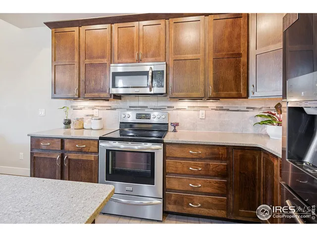 a kitchen with a refrigerator and a sink