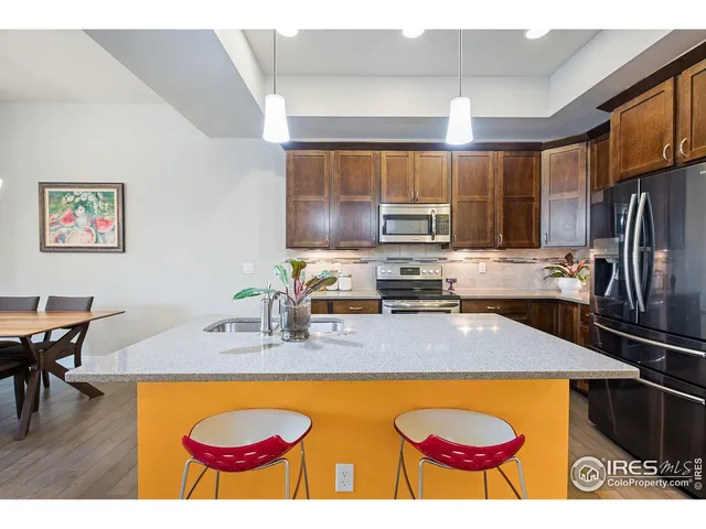 a kitchen with sink stove and cabinets