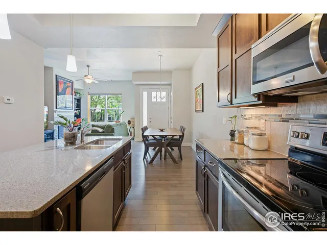 a living room with furniture and kitchen view
