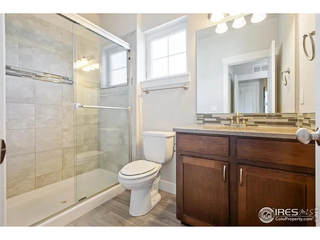 a bedroom with a bed and a desk