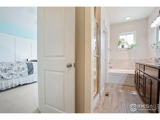 a bathroom with a tub sink and a mirror