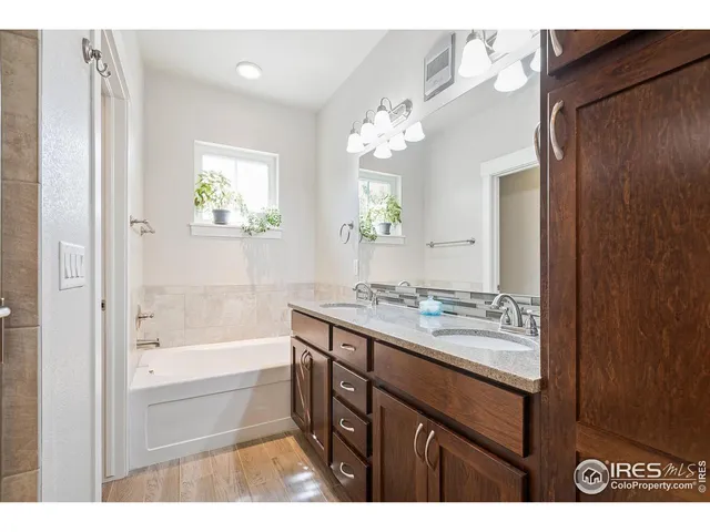 a bathroom with a granite countertop sink a toilet and a bathtub