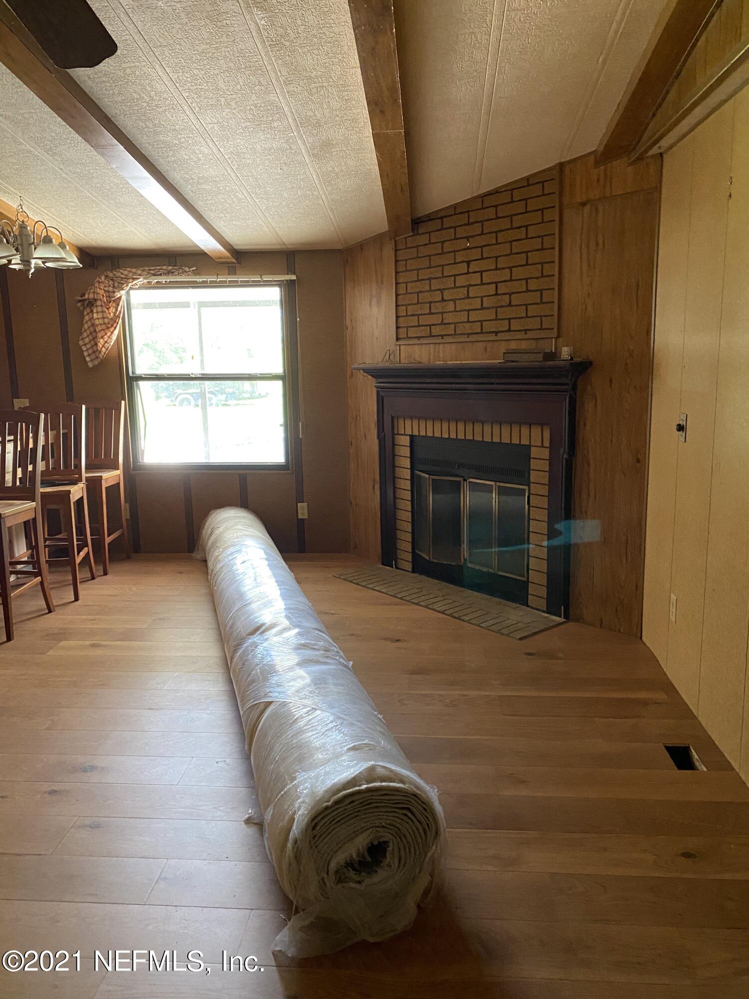 140 Keystone Road Palatka, FL 32177 - Photo 11 of 33 a living room with furniture or window and a fireplace