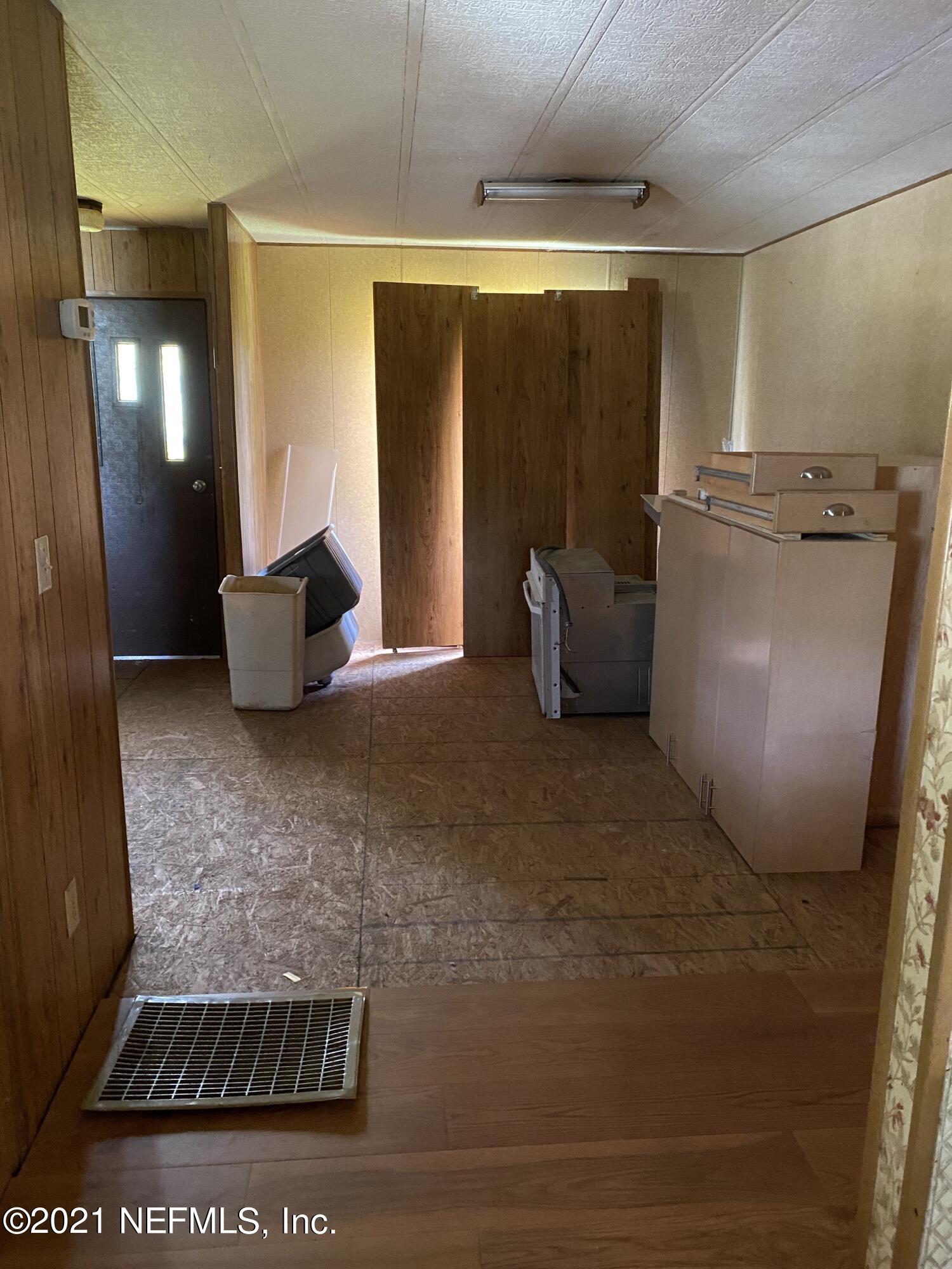 140 Keystone Road Palatka, FL 32177 - Photo 12 of 33 a view of an empty room with wooden floor and a window