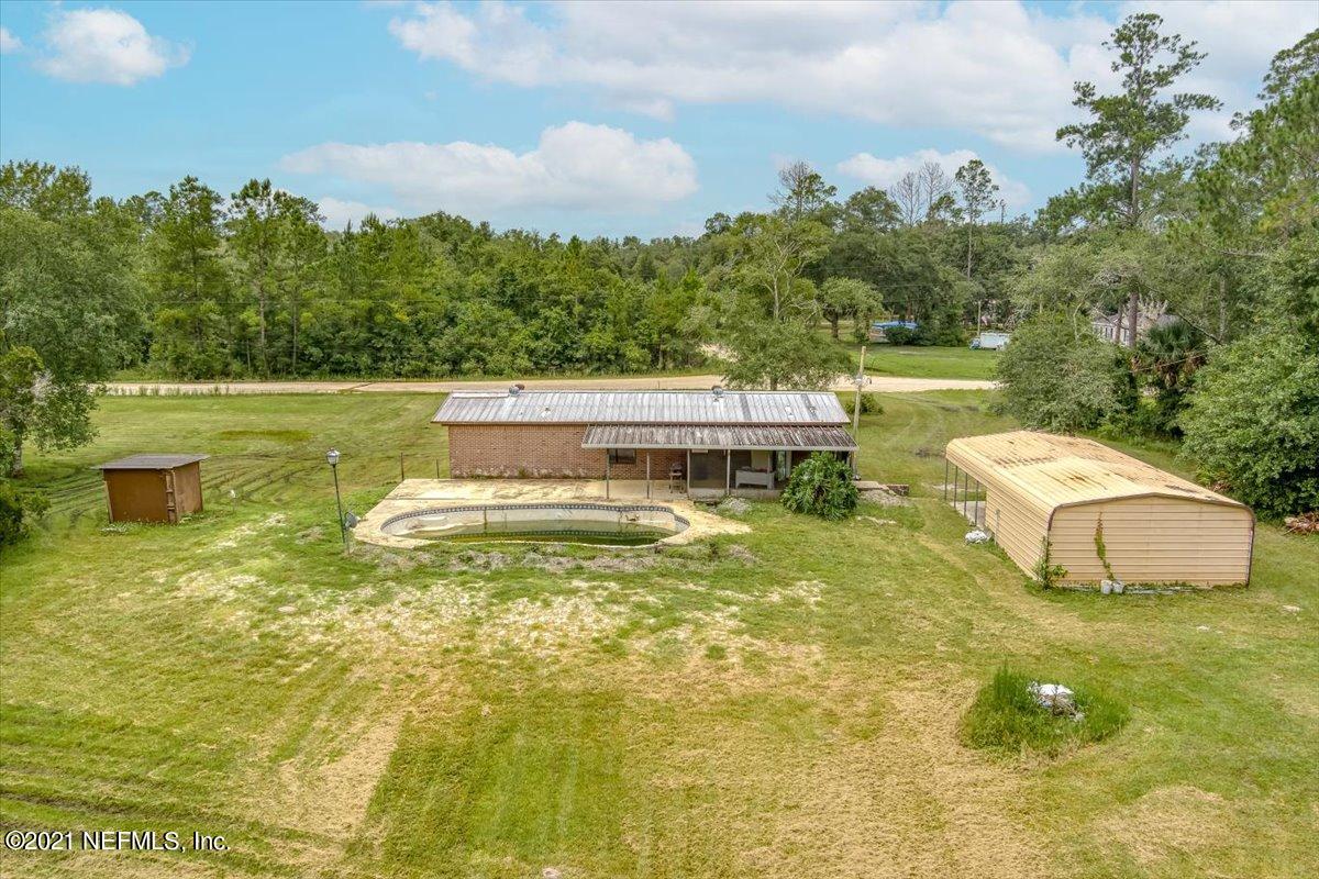 140 Keystone Road Palatka, FL 32177 - Photo 18 of 33 a view of a swimming pool with an outdoor seating and a garden