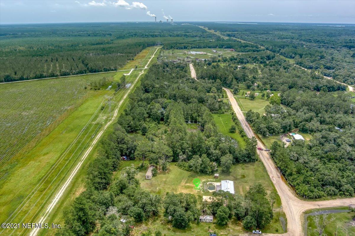 140 Keystone Road Palatka, FL 32177 - Photo 28 of 33 a view of a lush green forest with a lake