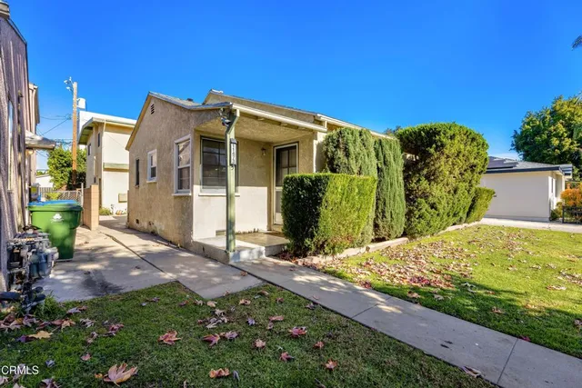 a view of a house with wooden fence