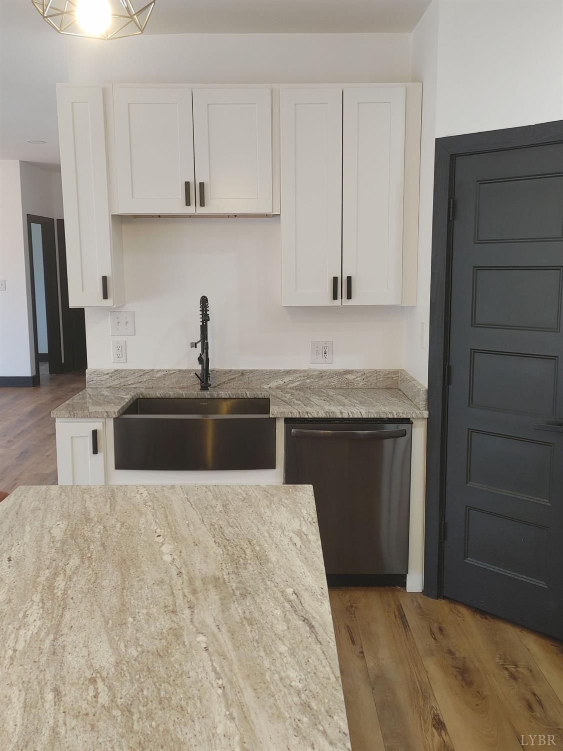 8915 Charlemont Road Goode, VA 24556 - Photo 12 of 96 a kitchen with granite countertop a sink stove and cabinets