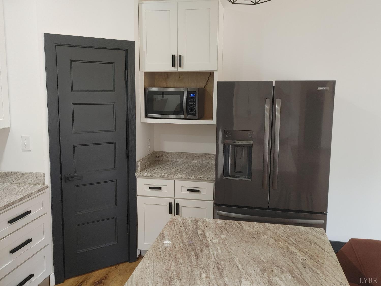 8915 Charlemont Road Goode, VA 24556 - Photo 15 of 96 a kitchen with a refrigerator and cabinets