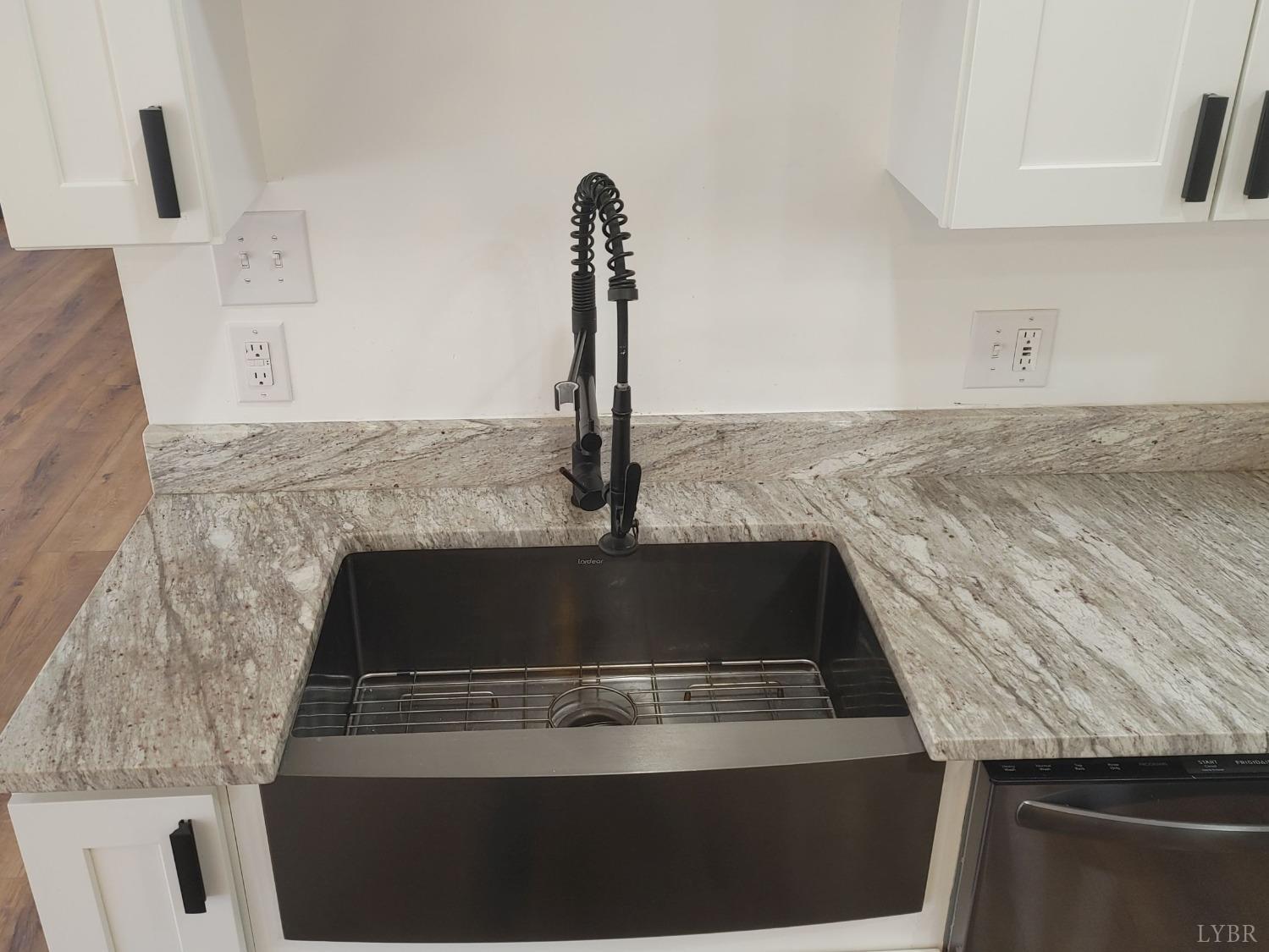 8915 Charlemont Road Goode, VA 24556 - Photo 17 of 96 a kitchen with granite countertop a stove and a sink