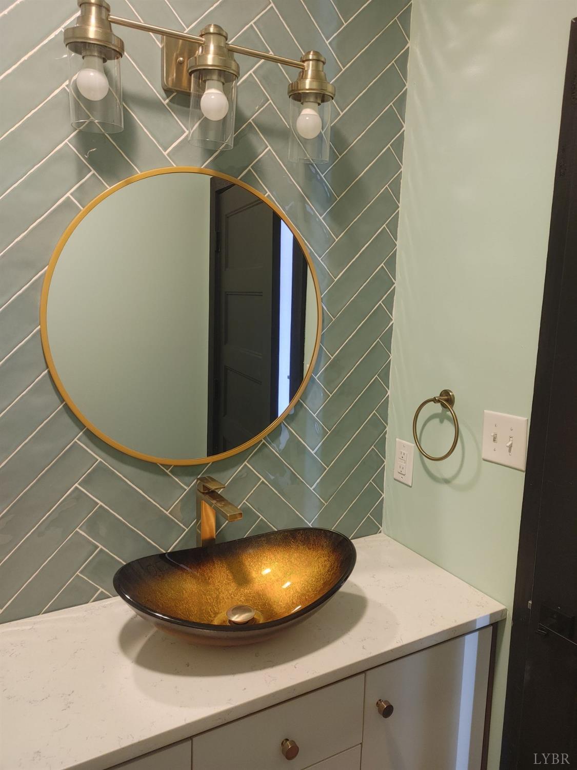 8915 Charlemont Road Goode, VA 24556 - Photo 26 of 96 a bathroom with a sink and mirror