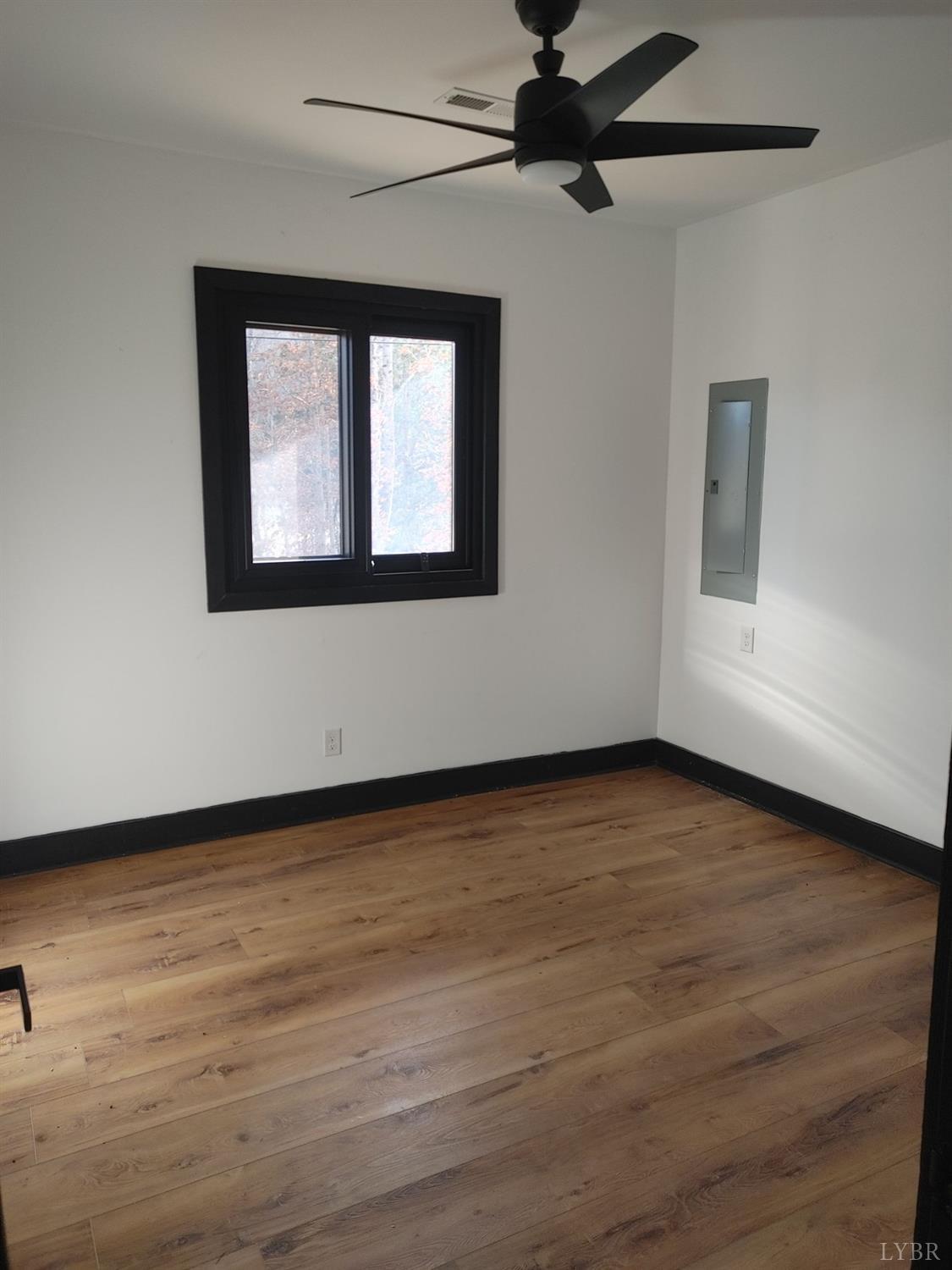 8915 Charlemont Road Goode, VA 24556 - Photo 27 of 96 a view of an empty room with wooden floor and a window