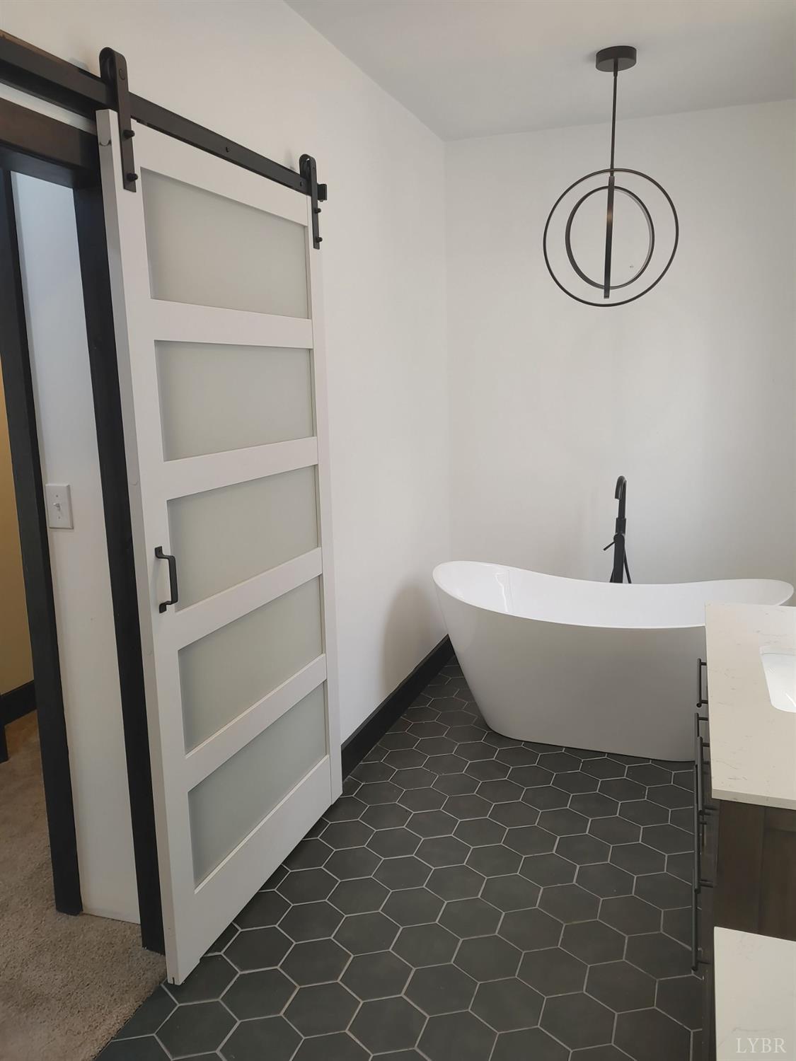 8915 Charlemont Road Goode, VA 24556 - Photo 53 of 96 a bathroom with a bathtub and a shower