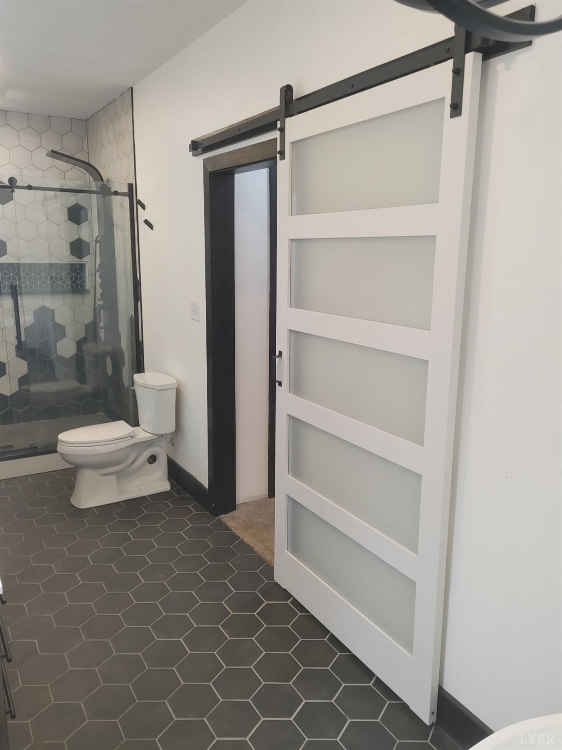 8915 Charlemont Road Goode, VA 24556 - Photo 57 of 96 a bathroom with a toilet and a shower