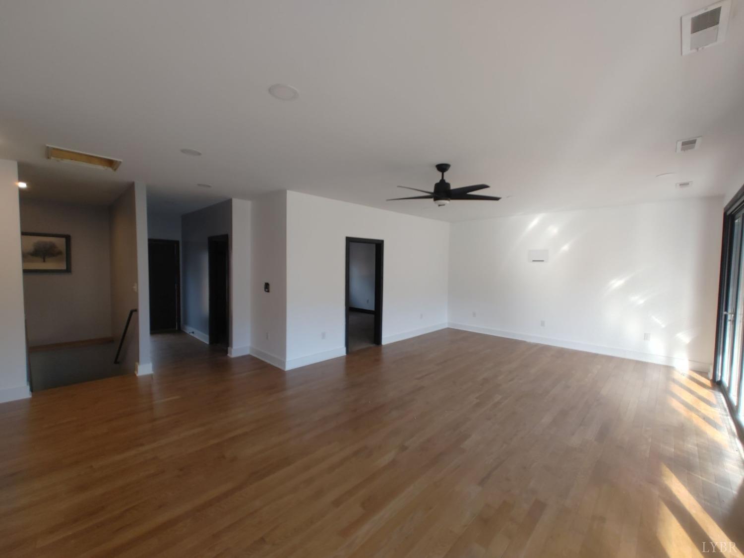 8915 Charlemont Road Goode, VA 24556 - Photo 80 of 96 a view of an empty room with wooden floor and a window