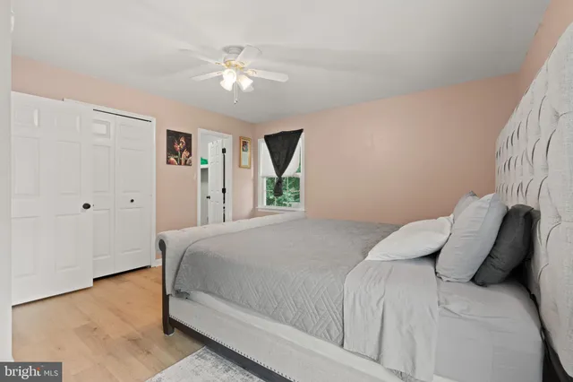 a bedroom with a large bed and a chandelier