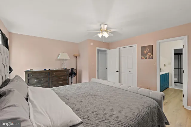 a bedroom with a large bed and chandelier