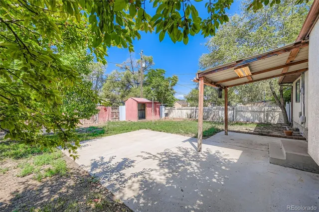 a view of a house with a yard and tree s