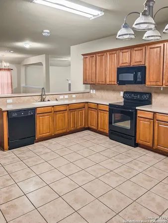 a kitchen with stainless steel appliances granite countertop a stove sink and cabinets