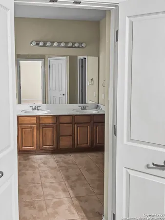 a bathroom with a sink a mirror and a vanity