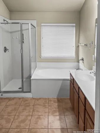 a bathroom with a tub sink and shower