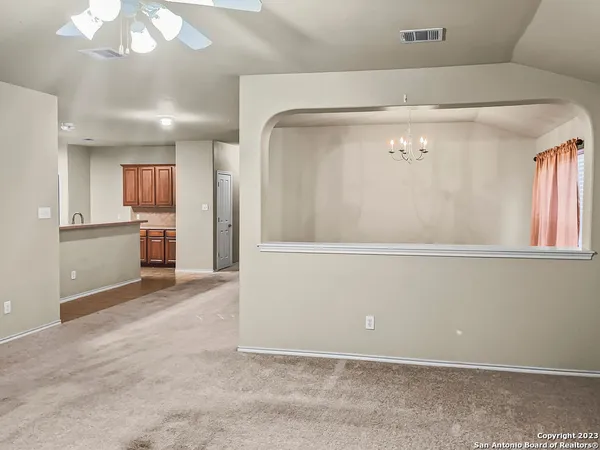 an empty room with wooden floor and a large window
