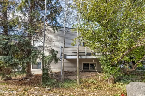 a front view of a house with a tree
