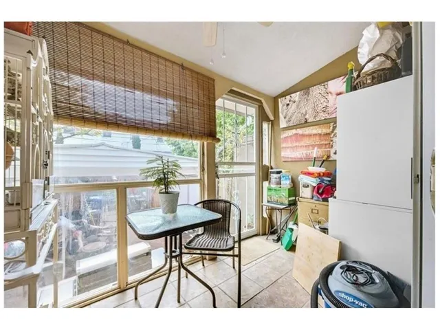 a view of a dining room with furniture and a window