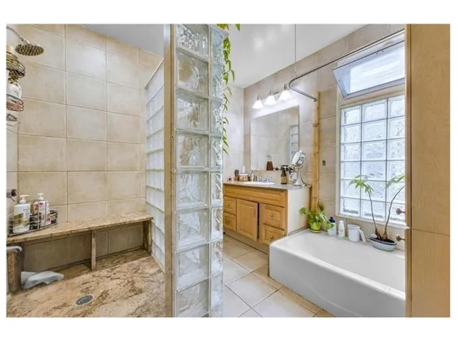 a bathroom with a sink a toilet a mirror and shower