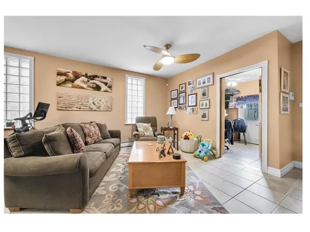 a living room with furniture and large window