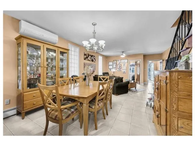 a dining room with furniture a chandelier and window