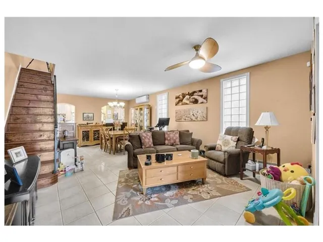 a living room with furniture and a lamp