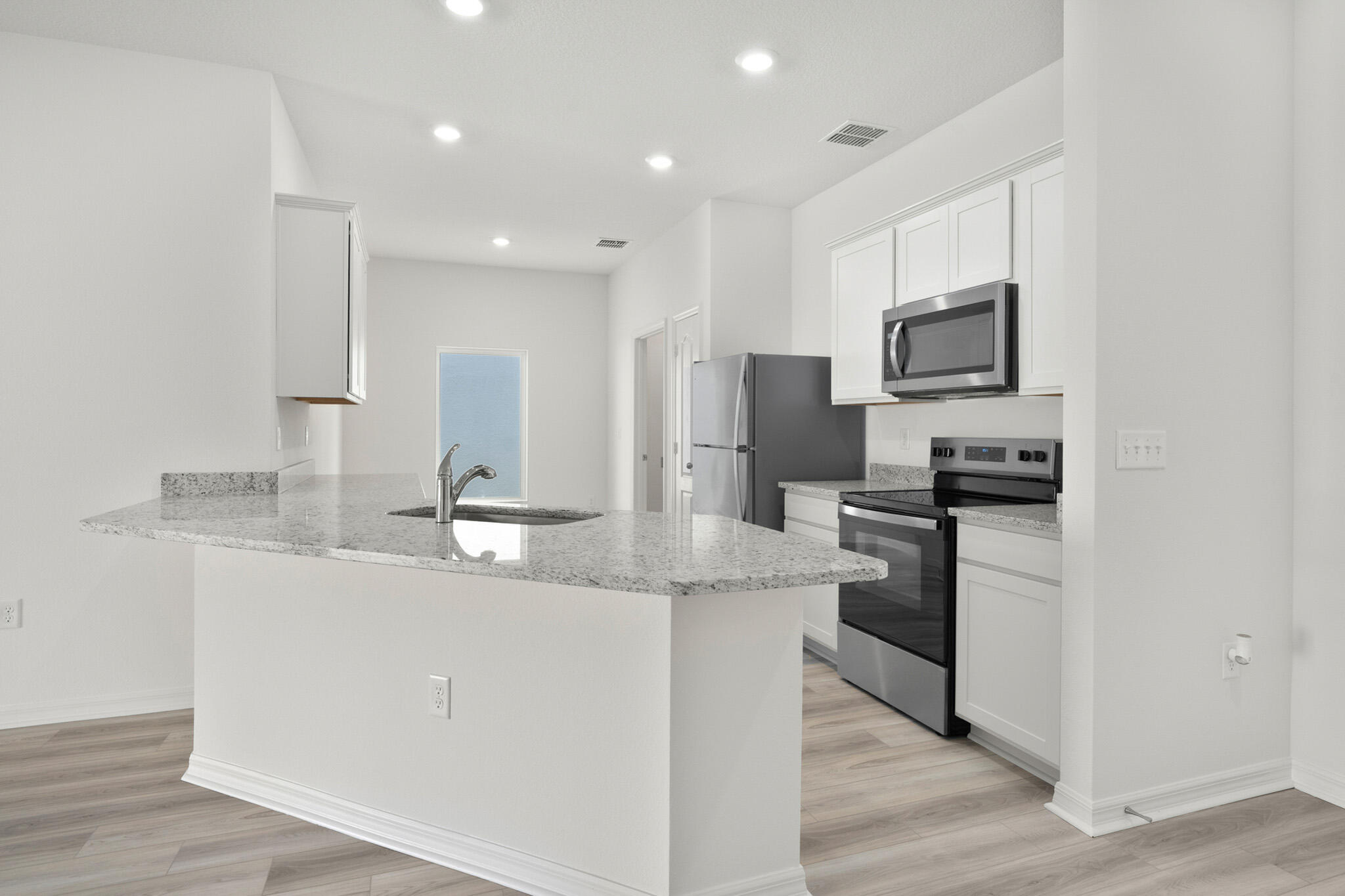 5019 Sunset Boulevard Fort Pierce, FL 34982 - Photo 3 of 20 a kitchen with kitchen island a sink stainless steel appliances and cabinets