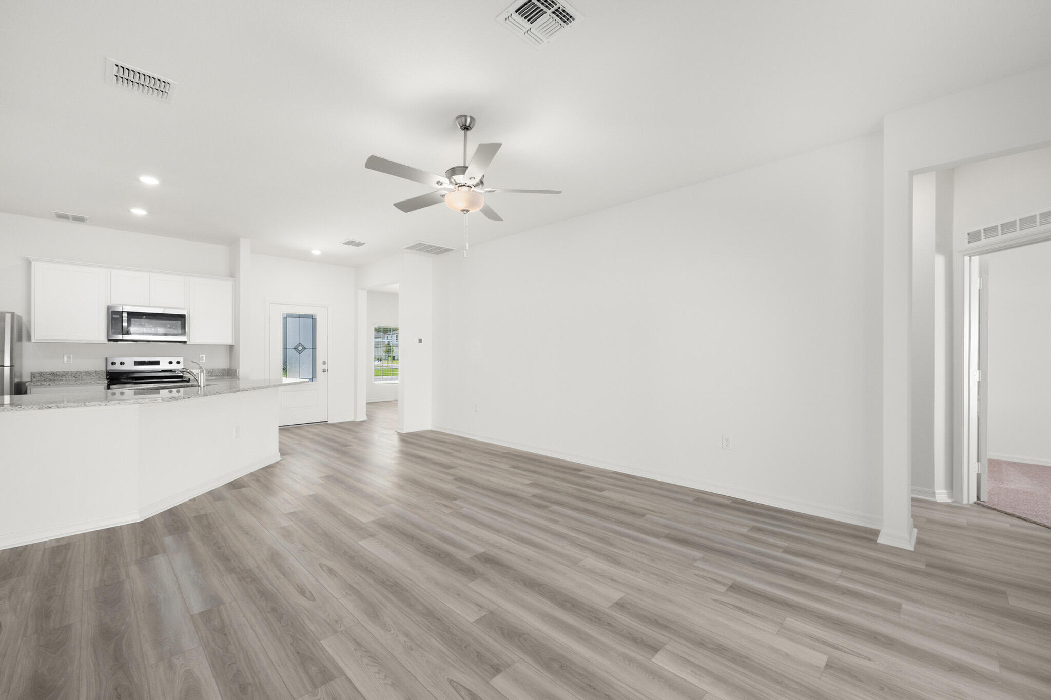 5019 Sunset Boulevard Fort Pierce, FL 34982 - Photo 7 of 20 a view of kitchen with microwave and wooden floor