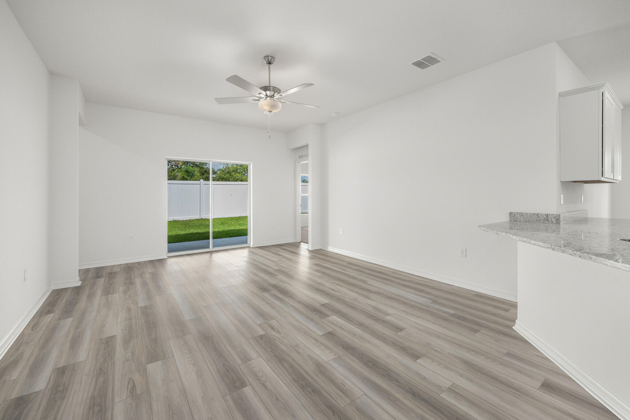 5019 Sunset Boulevard Fort Pierce, FL 34982 - Photo 8 of 20 wooden floor in an empty room with a window