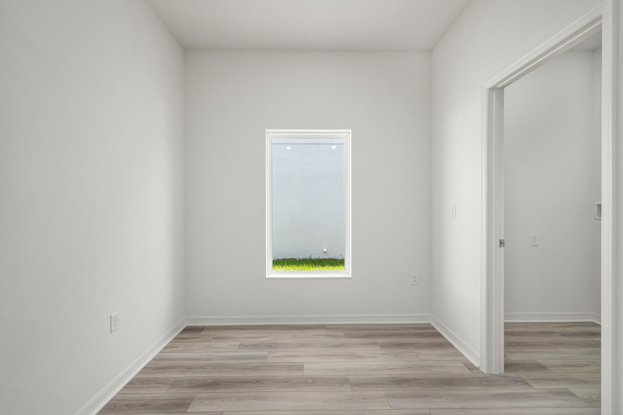 5019 Sunset Boulevard Fort Pierce, FL 34982 - Photo 9 of 20 a view of an empty room with wooden floor and a window
