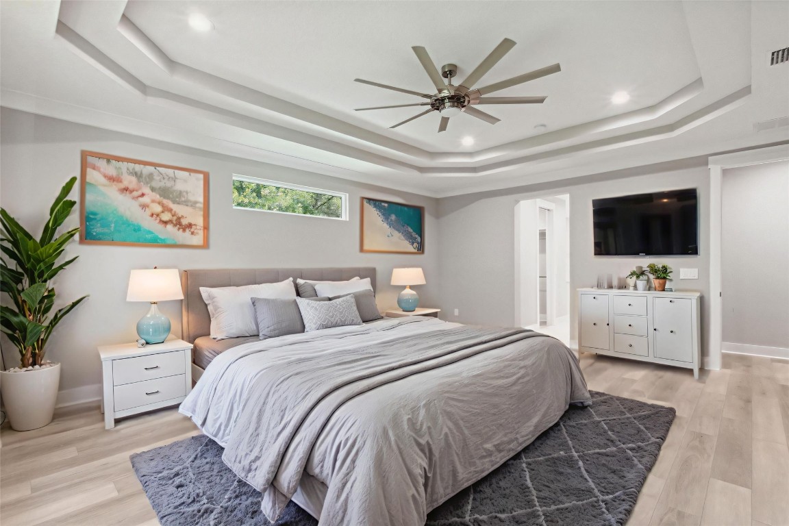 96050 Captains Pointe Road Yulee, FL 32097 - Photo 16 of 37 a bedroom with a large bed and a chandelier