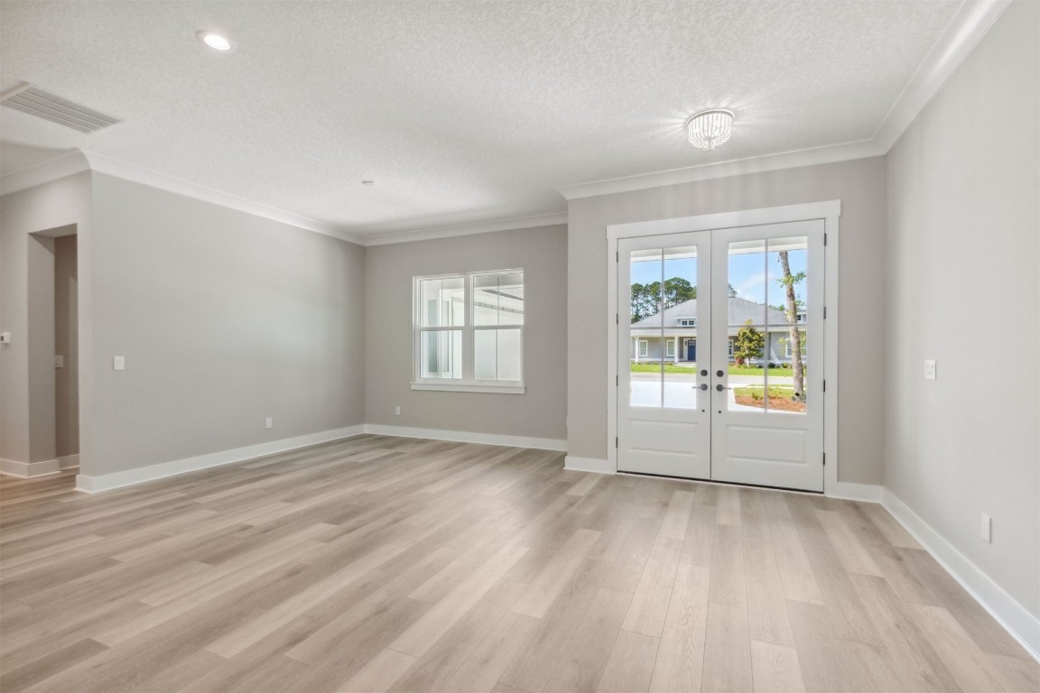 96050 Captains Pointe Road Yulee, FL 32097 - Photo 4 of 37 an empty room with wooden floor and windows