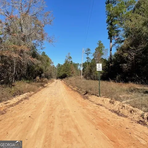 a view of a yard covered with snow in front of house