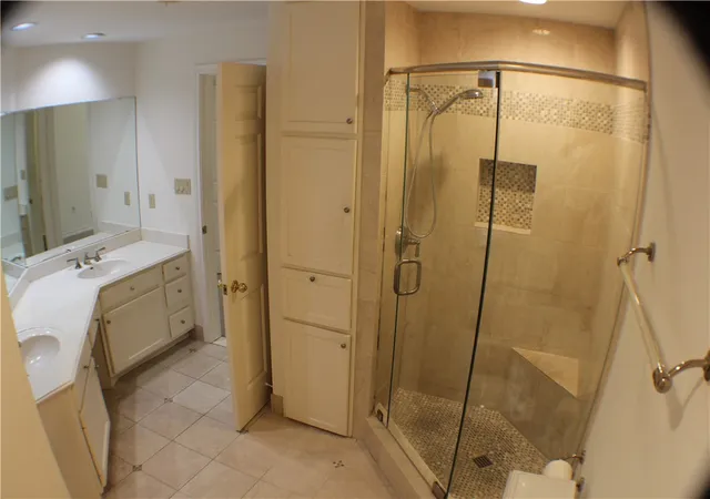 a bathroom with a mirror a sink and shower