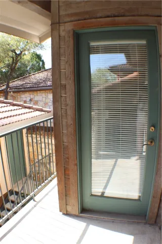 a view of a glass door with a bench